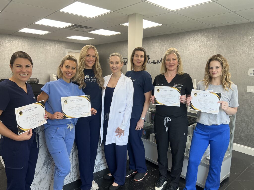Coastal Aesthetic Training graduating class of June 2025 in Mystic Connecticut holding certificates after completing injection training.

